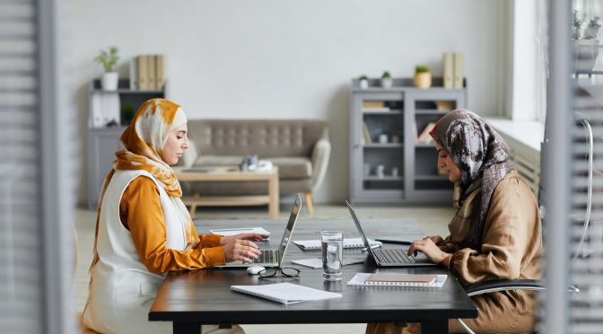 women typing on their laptop