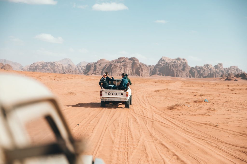 photo of people riding on pickup truck