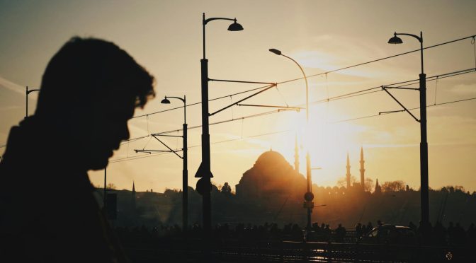 a person in a city at sunset