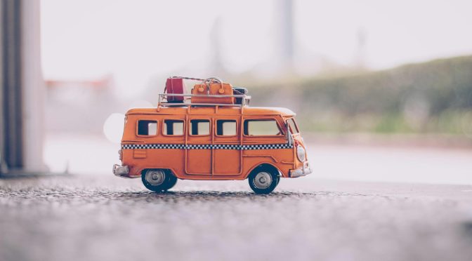 orange van die cast model on pavement