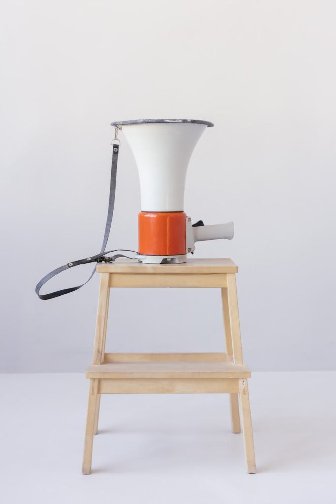 loudspeaker on top of wooden stool