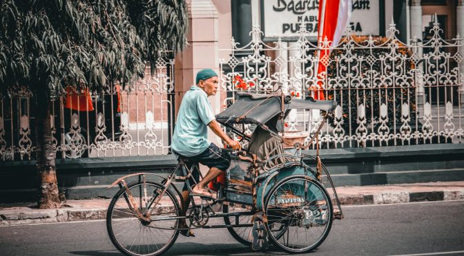 a man riding a tricycle
